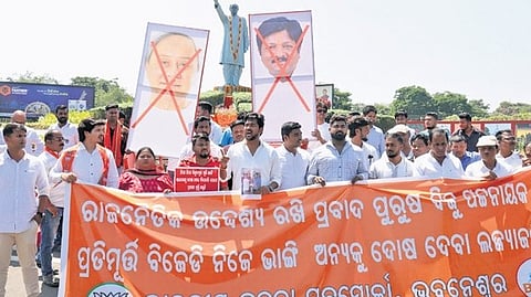 BJP Yuva Morcha activists protest near the statue of former CM Biju Patnaik at  Biju Patnaik International Airport on Thursday 