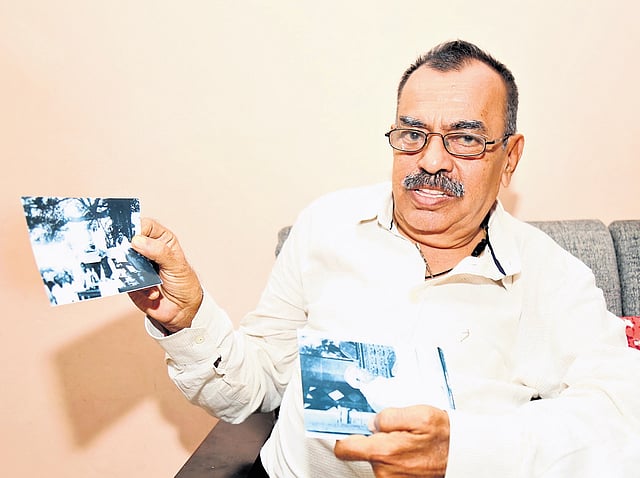 Rahul N Asher showing photos of Gandhiji’s visit to Fort Kochi.