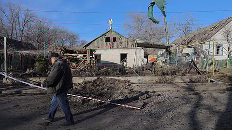 A local resident walks past damaged houses, a day after a Russian strike on a suburb of Odesa, southern Ukraine on March 7, 2025