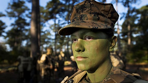 In this image provided by the U.S. Marine Corps, Pfc. Christina Fuentes Montenegro prepares to hike to her platoon's defensive position during patrol week of Infantry Training Battalion near Camp Geiger, N.C. Oct. 31, 2013.