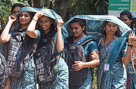 Students in Bengaluru covering their head with sarees due to heat wave ahead of the well ahead of the summer. 