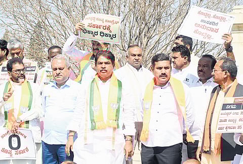 BJP and JDS legislators protest against the Karnataka Congress government outside Vidhana Soudha on Friday.