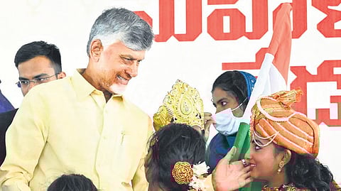 Chief Minister Nara Chandrababu Naidu interacting with children dressed as freedom fighters at the International Women’s Day celebrations