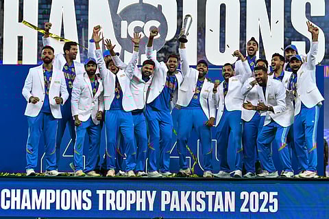 India spinner Varun Chakravarthy lifts the trophy with the team on Sunday