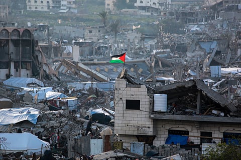 A Palestinian flag flutters amid the ruins of buildings in Beit Lahia in the northern Gaza Strip on March 4, 2025, amid the ongoing truce between Israel and Hamas. 
