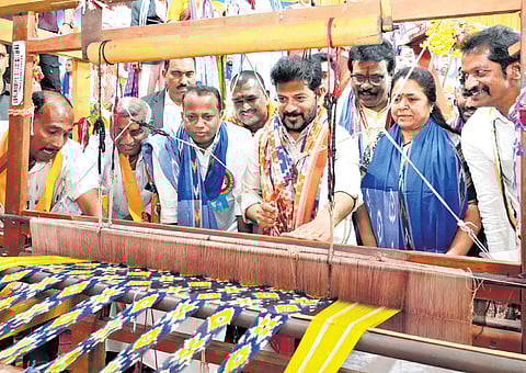Chief Minister A Revanth Reddy tries his hand at handloom weaving during 
the Akhila Bharatha Padmashali Mahasabha in Hyderabad on Sunday