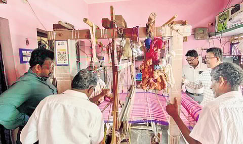 An inspection team studying the making of sarees in Narayanapuram