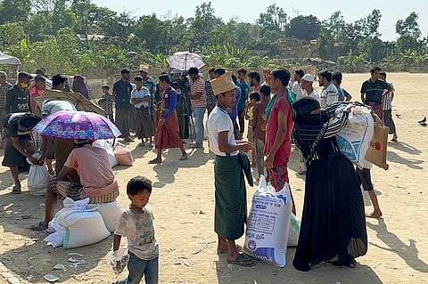 Rohingya refugees collect food stuff distributed by the World Food Programme (WFP) at their refugee camp at Kutupalong in Cox's Bazar, Bangladesh