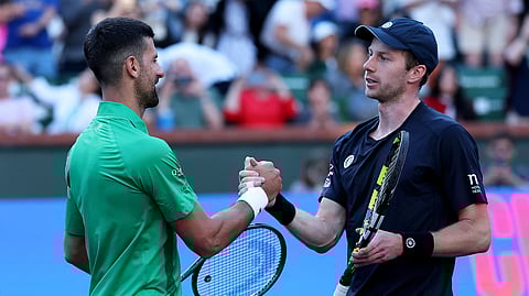 Novak Djokovic shakes hands at the net after his three set defeat against Botic van de Zandschulp of the Netherlands in their second round match during the BNP Paribas Open at Indian Wells Tennis Garden on March 08, 2025