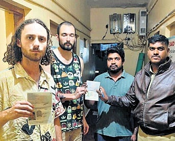 Police assure the safety of foreign tourists at a homestay in Hampi