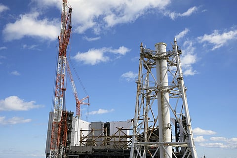 The damaged unit 1 reactor, back, and the exhaust stack shared by the unit 1 and 2 reactors are seen at the Fukushima Daiichi nuclear power plant, operated by Tokyo Electric Power Company Holdings (TEPCO), in Okuma town, northeastern Japan on Monday, Feb 20, 2025.