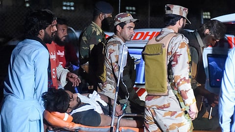 Security personnel and volunteers help to transport an injured train passenger following an operation against armed militants who ambushed the train in the remote mountainous area in Mach, southwestern Balochistan province on March 12, 2025.