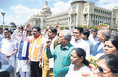 BJP and JDS leaders raise slogans against the state government, accusing it of misusing taxpayers’ money, outside Vidhana Soudha on Wednesday