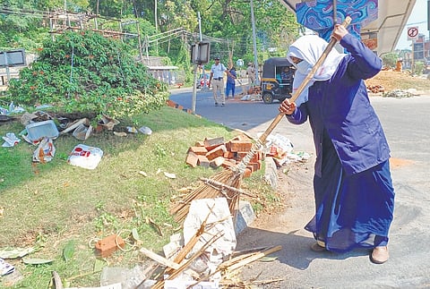 A city corporation sanitation worker during a cleaning drive following Attukal Pongala at Bakery Junction on Thursday.