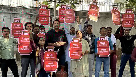 AAP functionaries protesting by carrying empty LPG cylinders as a symbol of what they called the BJP’s “broken promises”, 