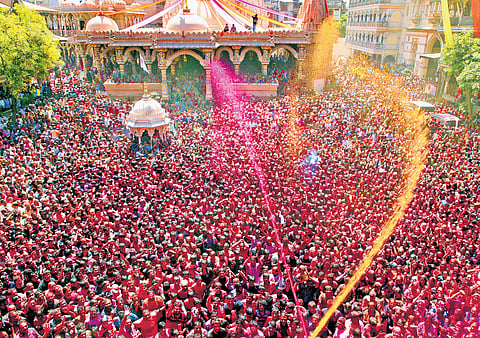 Coloured water being sprayed on devotees during Holi celebrations at Swaminarayan temple in Ahmedabad on Friday.