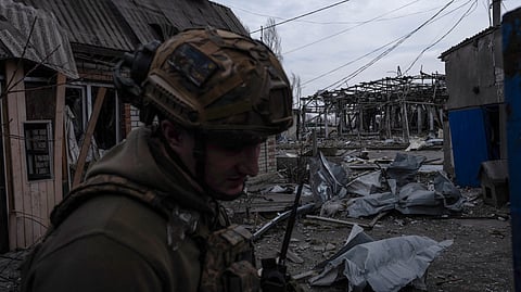 A Ukrainian serviceman stands among debris in an abandoned area in Pokrovsk, Donetsk region, amid the Russian invasion of Ukraine.