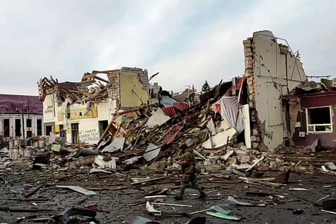 This video grab taken from a handout footage released by the Russian Defence Ministry on March 15, 2025, shows a Russian soldier walking along destroyed buildings in Sudzha, Kursk region, amid the ongoing Russian-Ukrainian conflict.