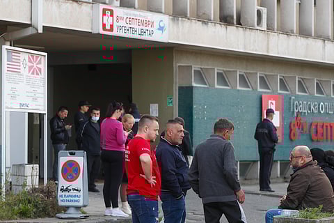 People wait in front of the hospital in Skopje, North Macedonia, Sunday, March 16, 2025, after a massive fire in a nightclub in the town of Kocani.