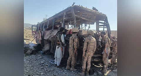 Security officials inspect the site in Naushki, Balochistan, where Baloch separatists attacked a bus carrying security forces.