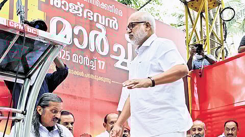 CPM leader M A Baby walks through the stage set up on a mini lorry for the inauguration of LDF’s protest against the Centre at Raj Bhavan on Monday 
