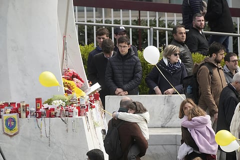 Faithful pray for Pope Francis outside the Agostino Gemelli polyclinic in Rome, Sunday, March 16, 2025.