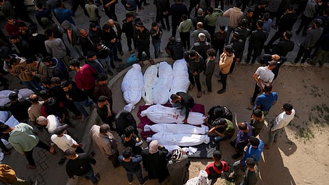 People gather around the bodies of Palestinians who were killed in an Israeli army airstrikes as they are brought to the Al-Ahli Hospital in Gaza City.