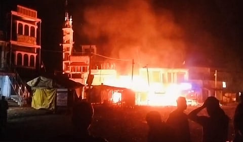 At least three shops were allegedly torched in a clash that broke out between two groups during a Holi procession, in Jharkhand's Giridih district, Friday, March 14, 2025. 