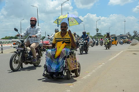 A person with disabilities navigates a busy road in Tirunelveli, on his battery-operated wheelchair. Representational image.