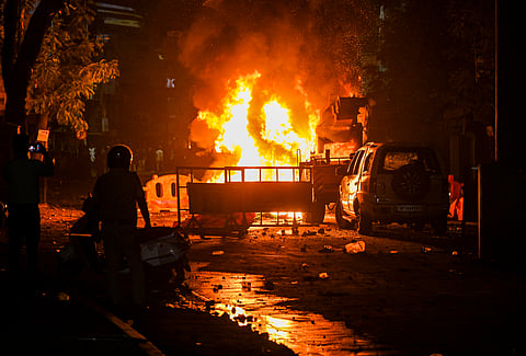 A fire set by miscreants amid violence following an agitation by a right-wing group demanding removal of Aurangzeb's tomb, in Nagpur on Monday night, March 17, 2025.