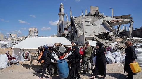 Displaced Palestinians, carrying their belongings traveling from Beit Hanoun to Jabaliya, a day after Israel's renewed offensive in the Gaza Strip, Wednesday, March 19, 2025.