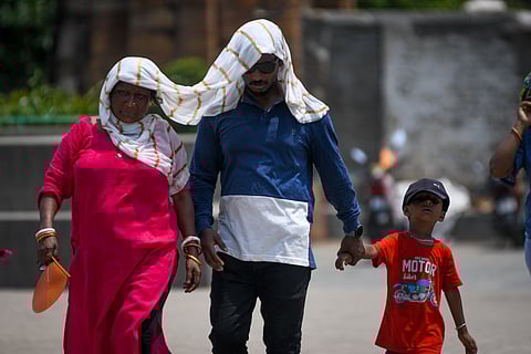 People cover their head to protect themsleves from heat in Bhubnaeswar