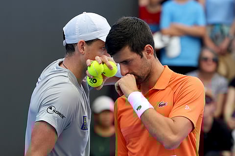 Canada's Vasek Pospisil and Serbia's Novak Djokovic talk tactics during their double match against during their Round of 32 match.