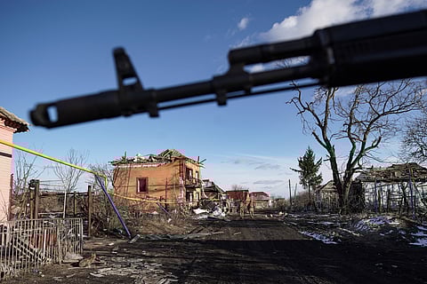 Russian soldiers walk past destroyed houses in the village of Kazachya Loknya, which was previously held by Ukrainian troops and recently retaken by Russia's armed forces, in the Sudzha district of the Kursk region on March 18, 2025, amid the ongoing Russian-Ukrainian conflict.
