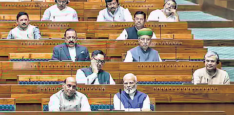 PM Narendra Modi with Defence Minister Rajnath Singh in the Lok Sabha