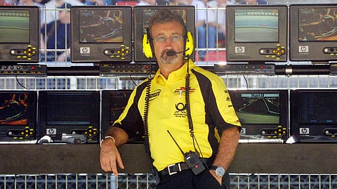 British Jordan-Honda Director Eddie Jordan sits on the pitwall of the Montmelo racetrack near Barcelona during the first free practice session, on April 26, 2002, two days before the Catalunya Formula One Grand Prix in Spain.
