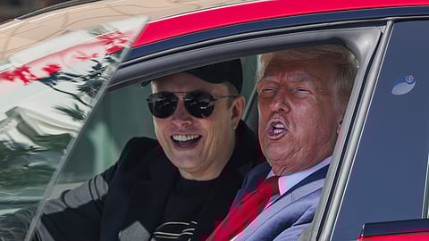 US President Donald Trump and Tesla CEO Elon Musk speak to reporters as they sit in a red Model S Tesla vehicle on the South Lawn of the White House Tuesday, March 11, 2025, in Washington.