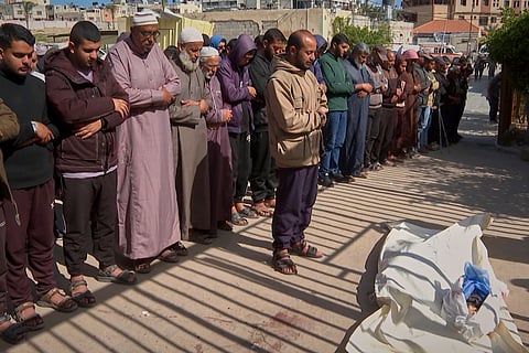 Palestinians pray over the bodies of Afnan al-Ghanam and her 13-month old son, Mohammed, at their funeral in Khan Younis, Gaza Strip, Wednesday, March 19, 2025.
