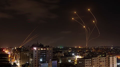 FILE - Rockets fired from Gaza and intercepted by Israel's Iron Dome anti-missile system over Israeli skies are seen from Gaza City, on May 13, 2023
