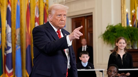 President Donald Trump gestures after signing executive order in the East Room of the White House in Washington, Thursday, March 20, 2025.