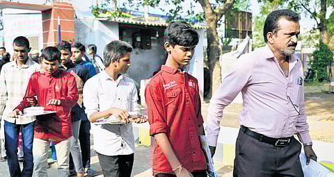 Visually challenged students reach an exam centre in Karimnagar on Friday.