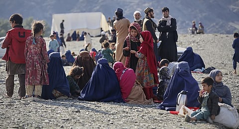Afghans wait to cross the closed Torkham border with Pakistan, where Pakistani and Afghan forces exchanged fire overnight, in Torkham, Afghanistan, Monday, March 3, 2025.