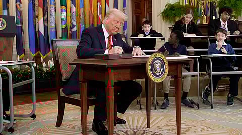 President Donald Trump signs an executive order in the East Room of the White House in Washington, Thursday, March 20, 2025.