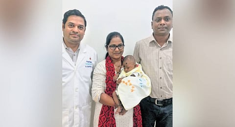 The baby with parents and the 
treating surgeon 