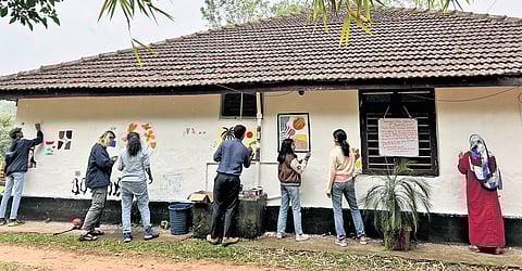 As part of the annual mental health awareness campaign, participants paint the walls of The Wheel Cafe in Madikeri 