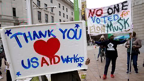 Supporters cheer the United States Agency for International Development (USAID) workers as they carry their personal belongings after retrieving them from the USAID's headquarters in Washington, Thursday, Feb. 27, 2025.