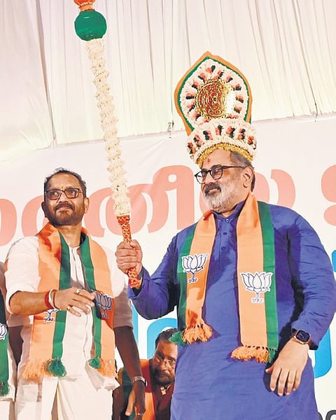 BJP’s new state president Rajeev Chandrasekhar wearing a headgear gifted by his predecessor K Surendran, in Thiruvananthapuram on Monday 