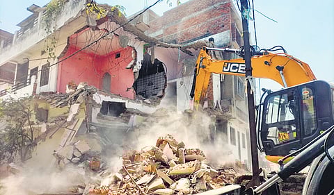 A bulldozer takes down the home of an accused in the Nagpur riot case 