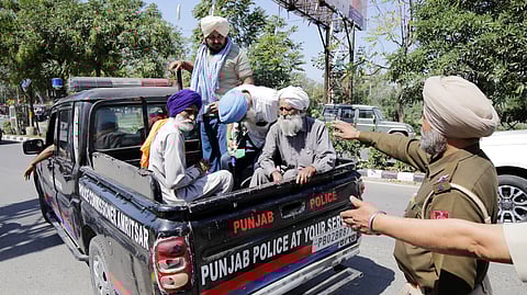 Punjab police detain farmers as they try to approach the Deputy Commissioner (DC) office to protest against the arrest of their farmer leaders, in Amritsar on Thursday, March 20, 2025.