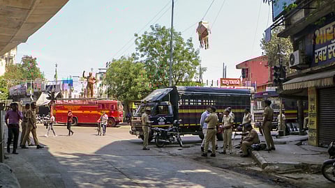 In this photo from March 18, 2025, police personnel keep a vigil at Chitnis Park area amid curfew after violence erupted the previous night, in Nagpur.